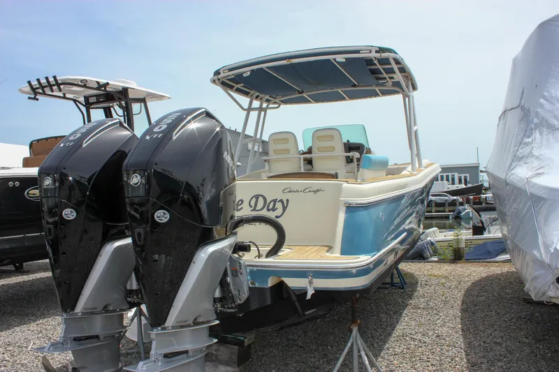 Slide: The Image of 2011 Chris-Craft Catalina 29 Sun Tender with dual outboard engines, docked on gravel. - 4