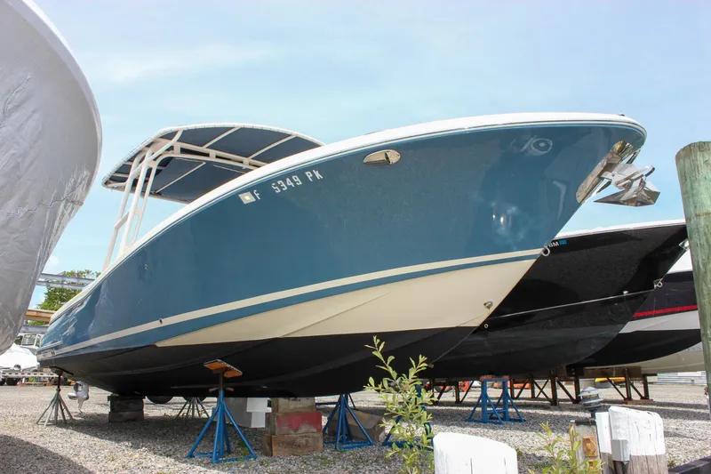Slide: The Image of 2011 Chris-Craft Catalina 29 Sun Tender boat on stands, blue hull, outdoor storage. - 5