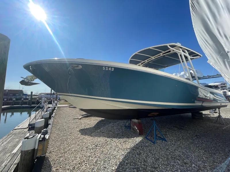 Slide: The Image of 2011 Chris-Craft Catalina 29 Sun Tender boat on dry dock under clear blue sky. - 9