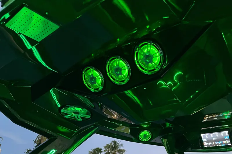 Slide: The Image of 2024 Adrenaline Reaper interior with vibrant green LED lighting and advanced audio system. - 10