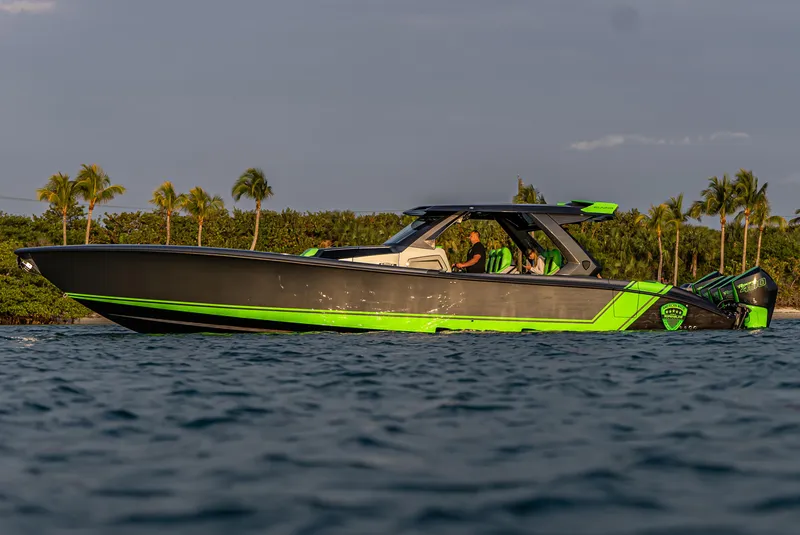 Slide: The Image of 2024 Adrenaline Reaper boat on water, sleek design, vibrant green accents, tropical background. - 11