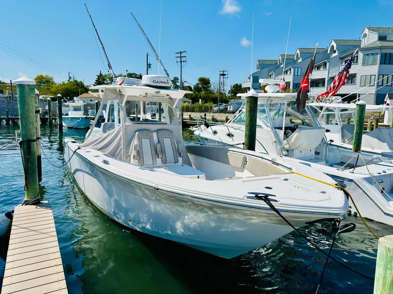 The Image of 2019 Sea Fox 328 Commander boat docked at marina under clear blue sky. - 0
