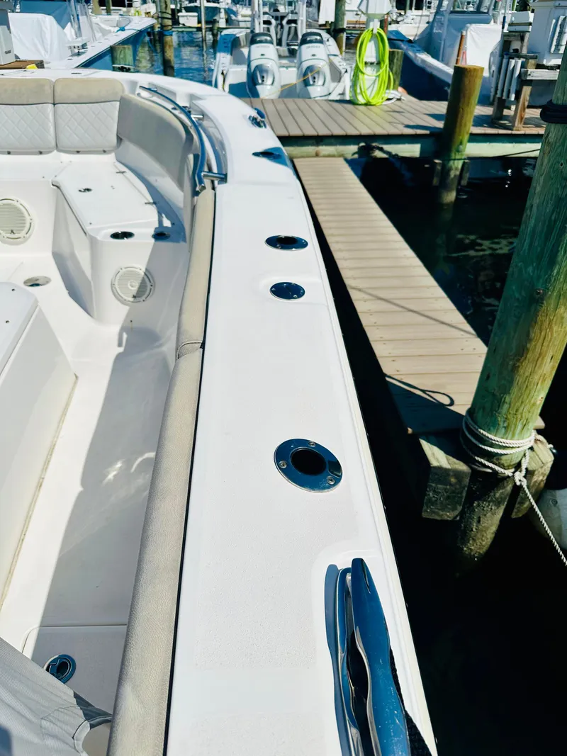 Slide: The Image of 2019 Sea Fox 328 Commander docked at marina, showcasing sleek design and spacious seating. - 11