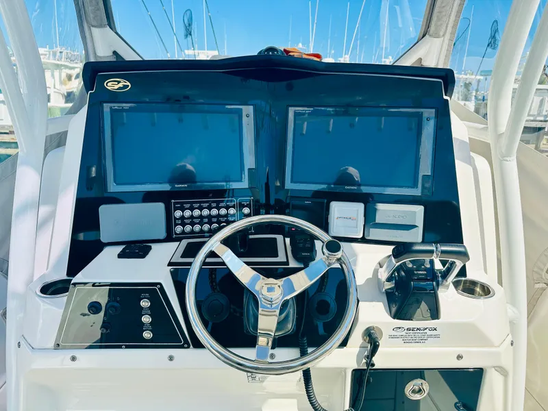 Slide: The Image of 2019 Sea Fox 328 Commander helm with dual displays and steering wheel. - 12