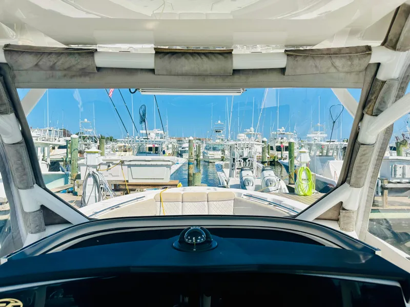 Slide: The Image of View from 2019 Sea Fox 328 Commander boat docked at marina, clear blue sky. - 13