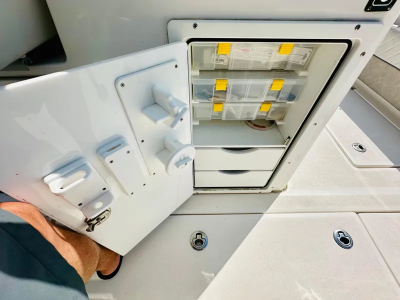 Slide: The Image of 2019 Sea Fox 328 Commander tackle storage with open door and organized compartments. - 17
