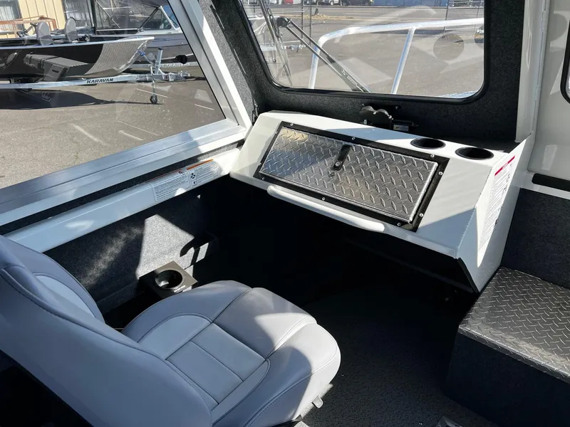 Slide: The Image of 2024 Thunder Jet 26 Alexis Pro XL interior with seating and storage compartment. - 11