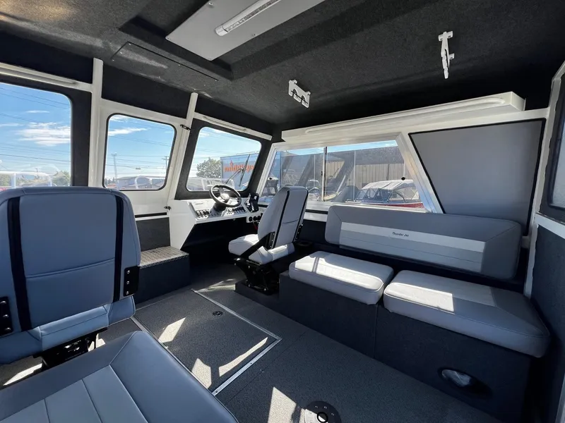 Slide: The Image of 2024 Thunder Jet 26 Alexis Pro XL interior with modern seating and steering console. - 17