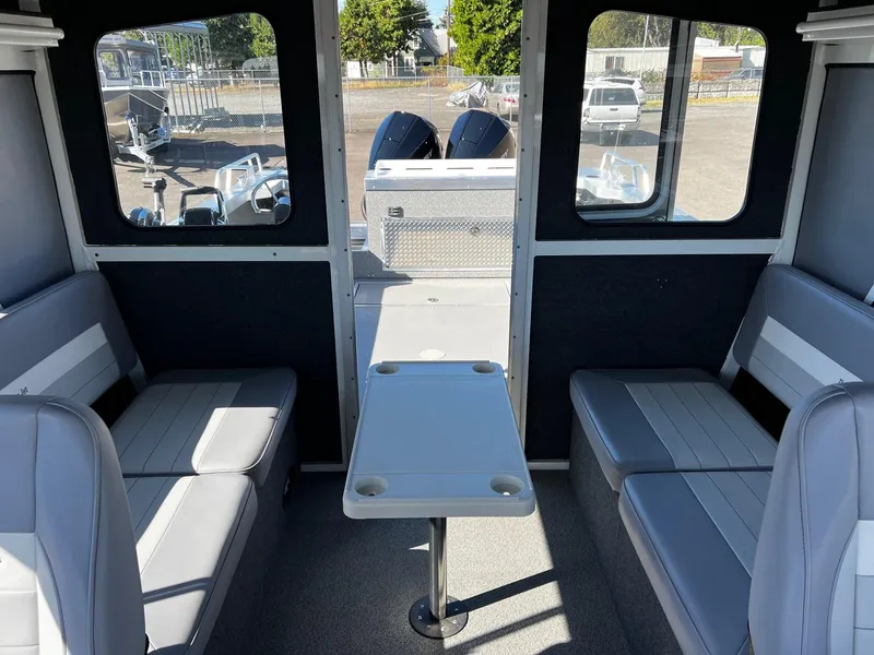 Slide: The Image of 2024 Thunder Jet 26 Alexis Pro XL interior with seating and table. - 19