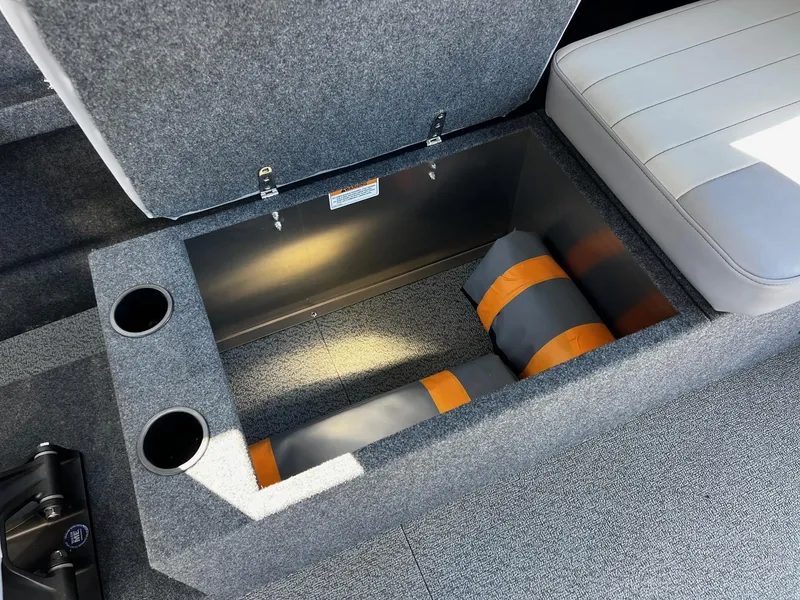 Slide: The Image of 2024 Thunder Jet 26 Alexis Pro XL interior storage compartment with cup holders and cushions. - 22