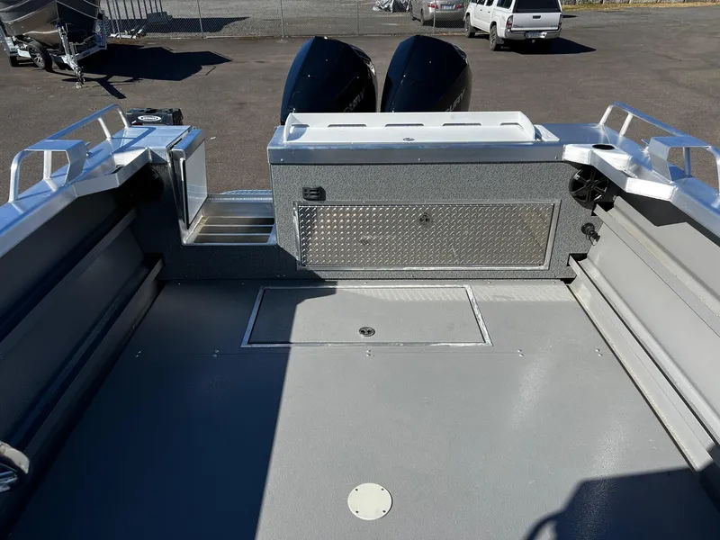 Slide: The Image of 2024 Thunder Jet 26 Alexis Pro XL boat deck with dual engines and storage compartment. - 24