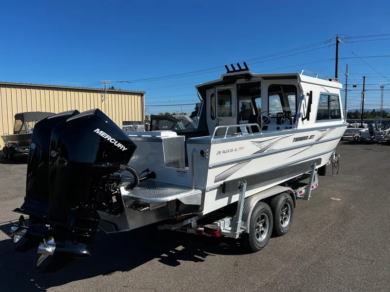 Slide: The Image of 2024 Thunder Jet 26 Alexis Pro XL boat with Mercury engine on trailer, parked outdoors. - 4