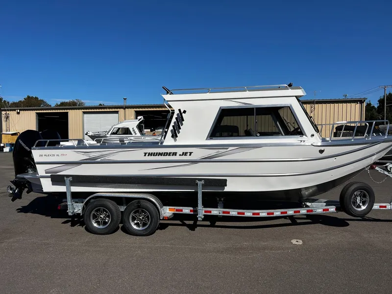 Slide: The Image of 2024 Thunder Jet 26 Alexis Pro XL boat on trailer, parked outdoors. - 5