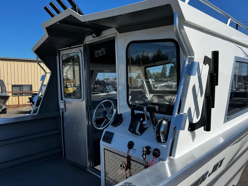 Slide: The Image of 2024 Thunder Jet 26 Alexis Pro XL boat cockpit with steering wheel and controls. - 7
