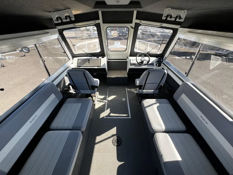 Slide: The Image of 2024 Thunder Jet 26 Alexis Pro XL interior with seating and steering wheel. - 9