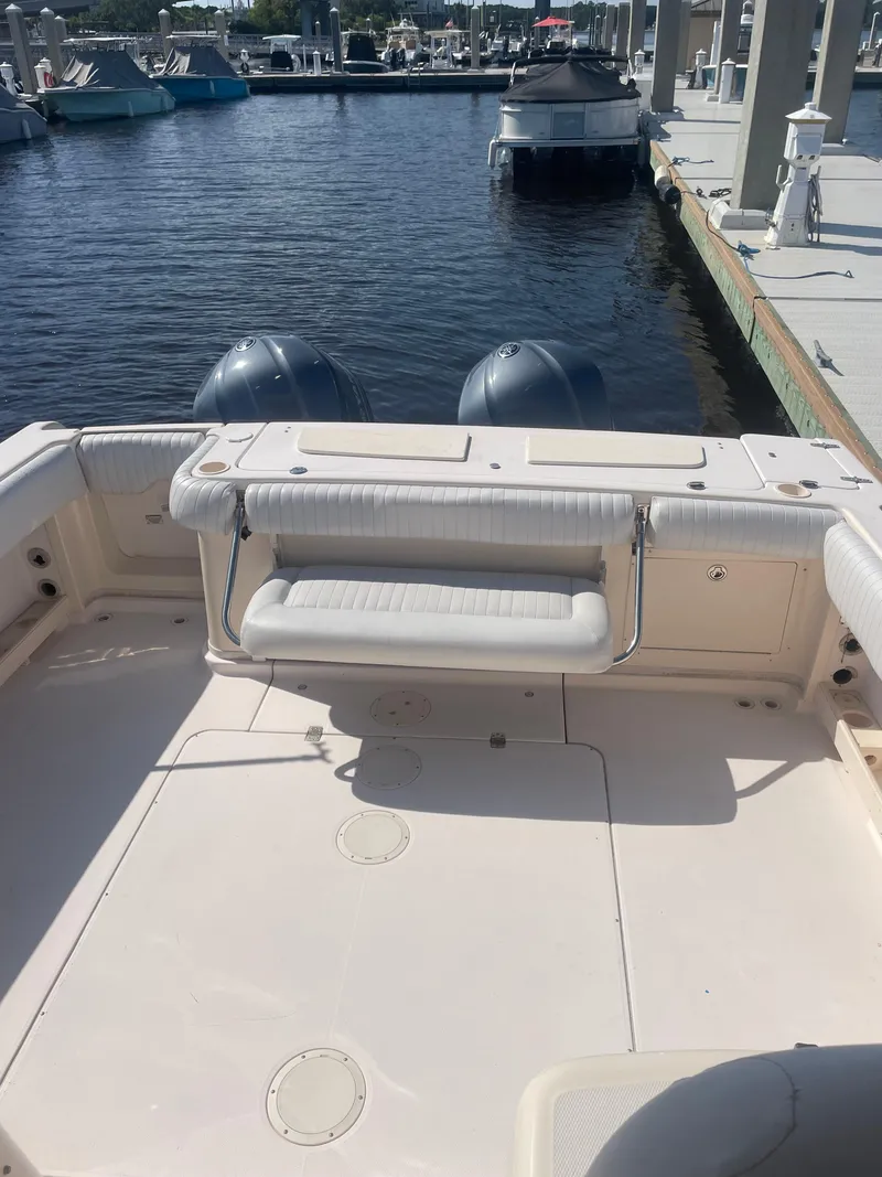 Slide: The Image of 2008 Grady-White Open Express boat at marina, featuring dual outboard motors. - 18