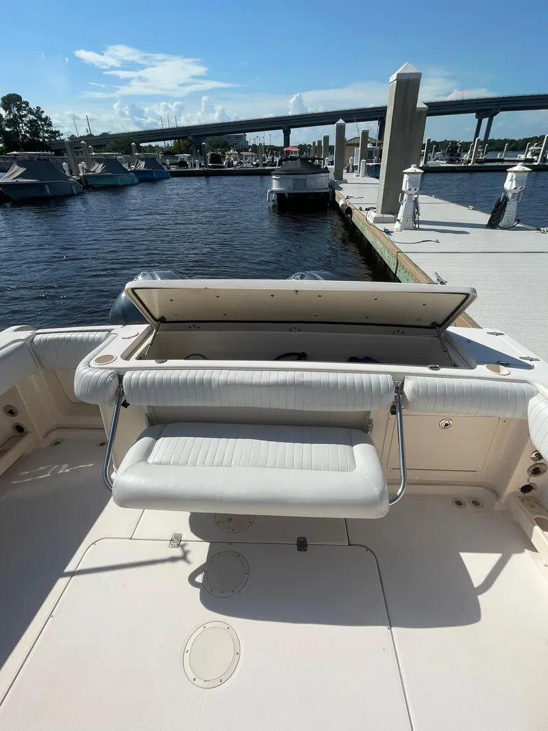 Slide: The Image of 2008 Grady-White Open Express boat at marina dock, featuring open seating area. - 19