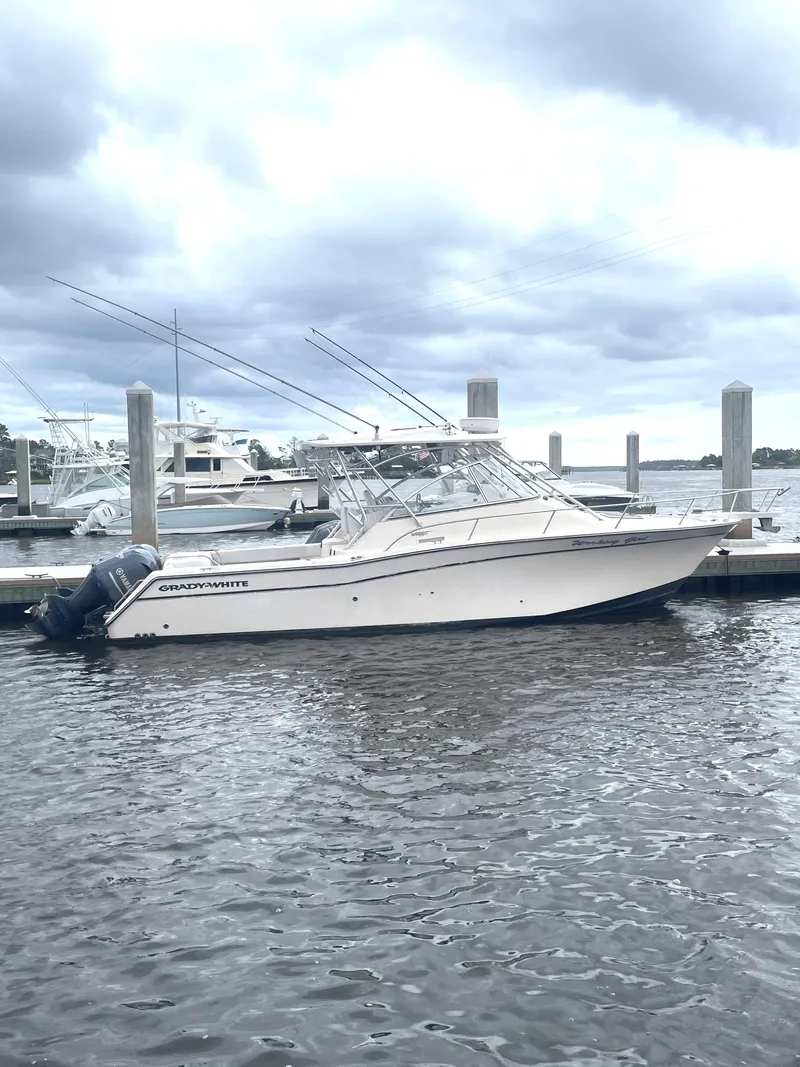 Slide: The Image of 2008 Grady-White Open Express boat docked at marina under cloudy sky. - 2