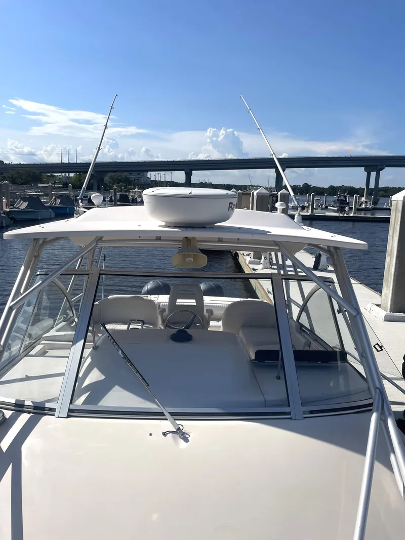 Slide: The Image of 2008 Grady-White Open Express boat docked under clear blue sky. - 24
