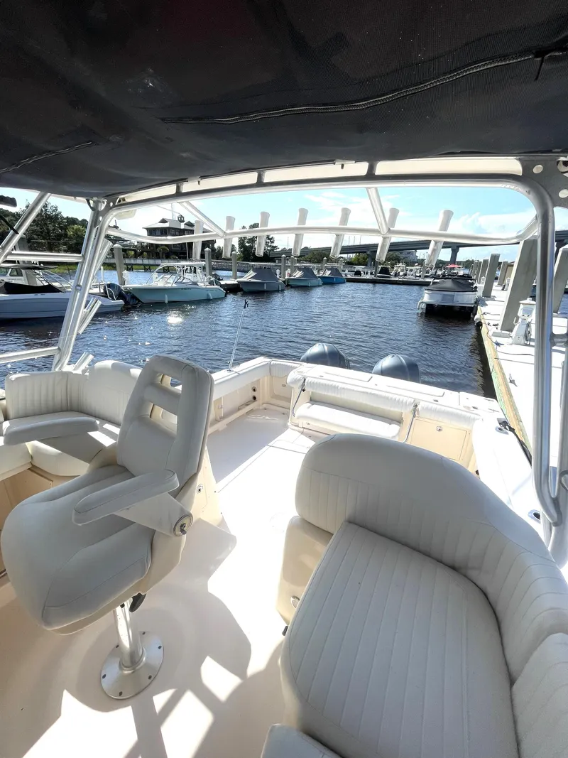 Slide: The Image of 2008 Grady-White Open Express boat interior at marina, featuring comfortable seating and scenic view. - 25