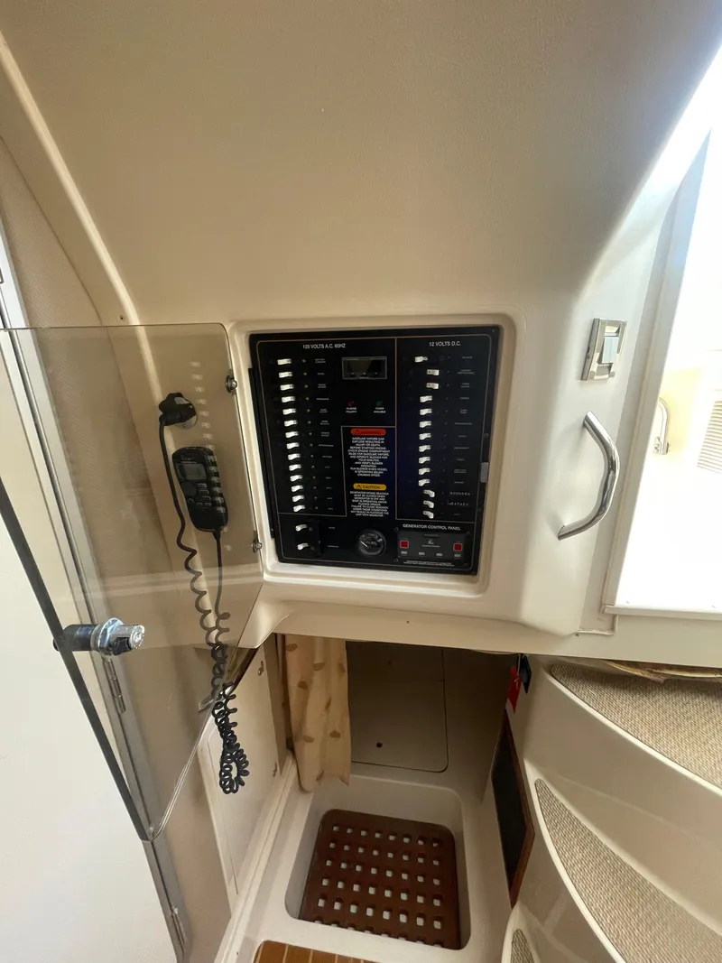 Slide: The Image of 2008 Grady-White Open Express control panel with communication equipment. - 27