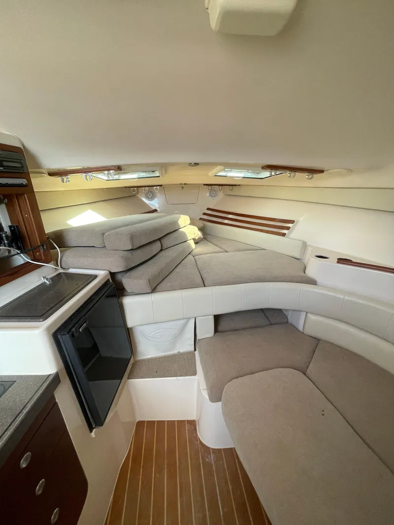 Slide: The Image of 2008 Grady-White Open Express cabin interior with seating and kitchenette. - 29