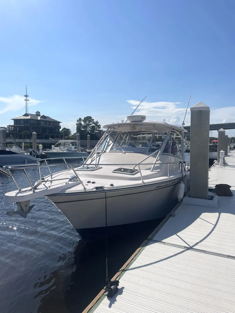 Slide: The Image of 2008 Grady-White Open Express boat docked at marina under clear blue sky. - 3
