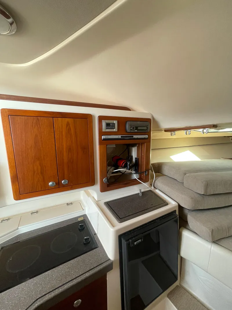 Slide: The Image of 2008 Grady-White Open Express cabin interior with kitchenette and seating area. - 30
