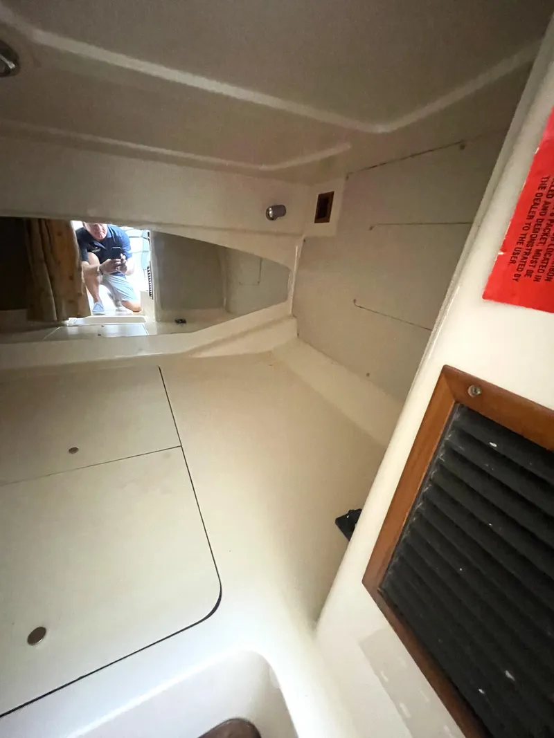 Slide: The Image of Interior cabin of 2008 Grady-White Open Express boat, featuring storage and ventilation. - 34