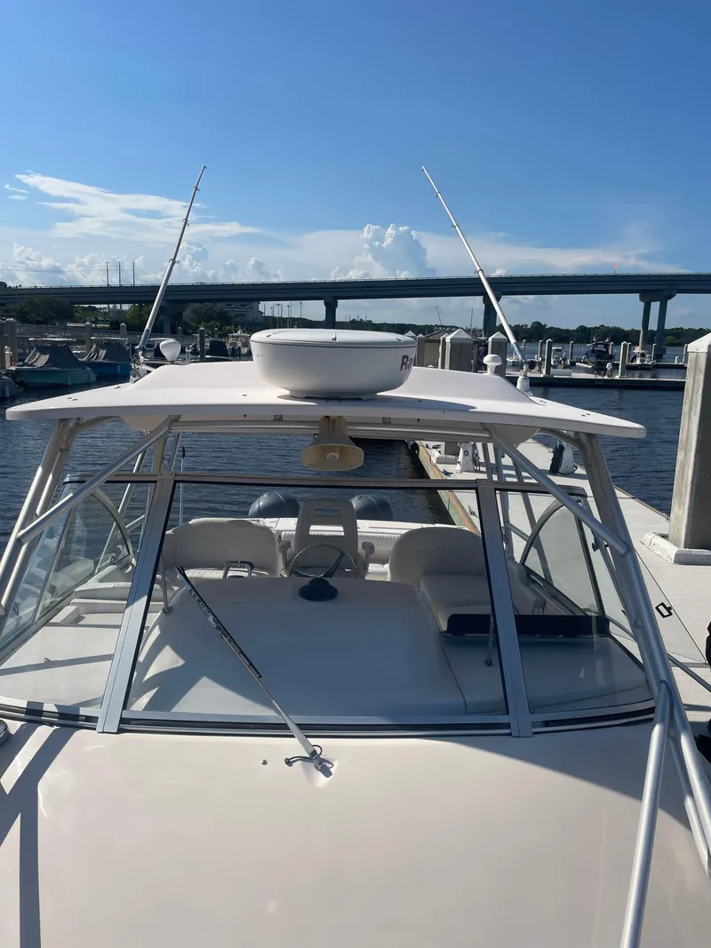 Slide: The Image of 2008 Grady-White Open Express boat docked under clear blue sky. - 8