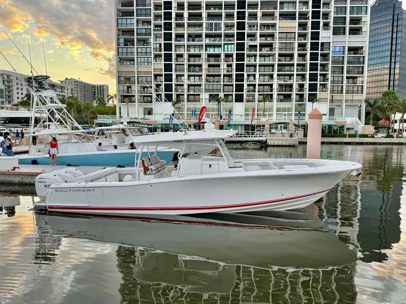 The Image of 2025 Southport 38 FE boat docked in marina with cityscape background. - 0