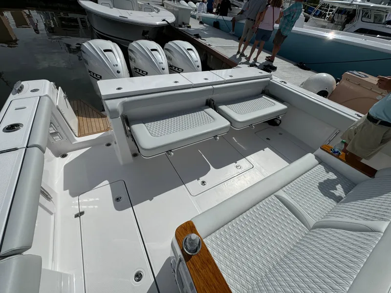 Slide: The Image of 2025 Southport 38 FE boat with triple outboard engines and spacious seating area. - 12