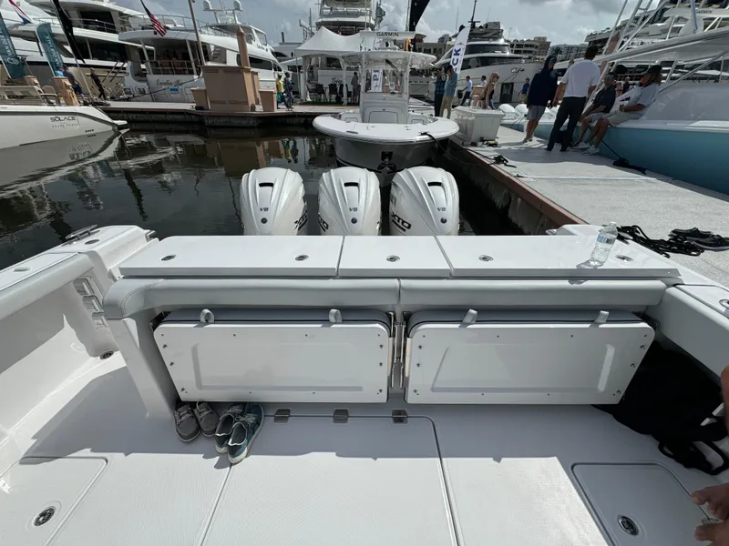 Slide: The Image of 2025 Southport 38 FE boat with triple outboard engines docked at a marina. - 14