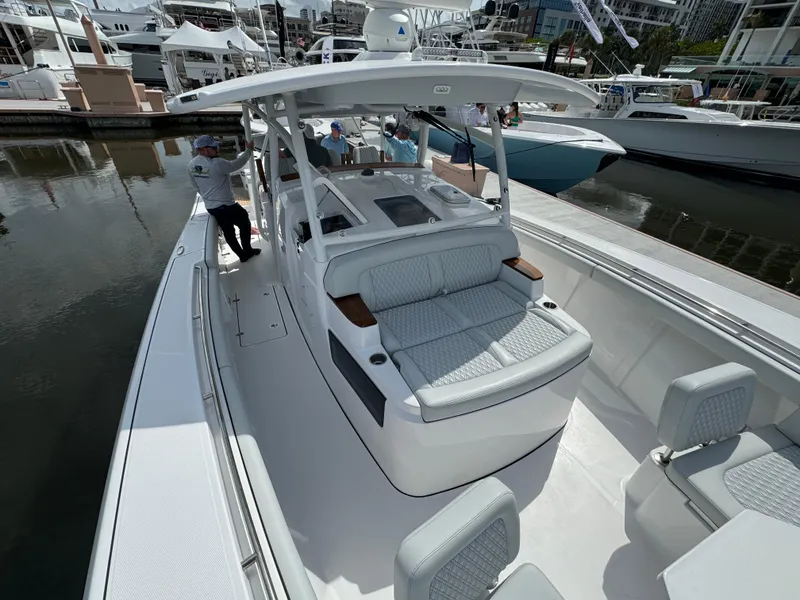 Slide: The Image of 2025 Southport 38 FE boat with spacious seating and modern design at a marina. - 21