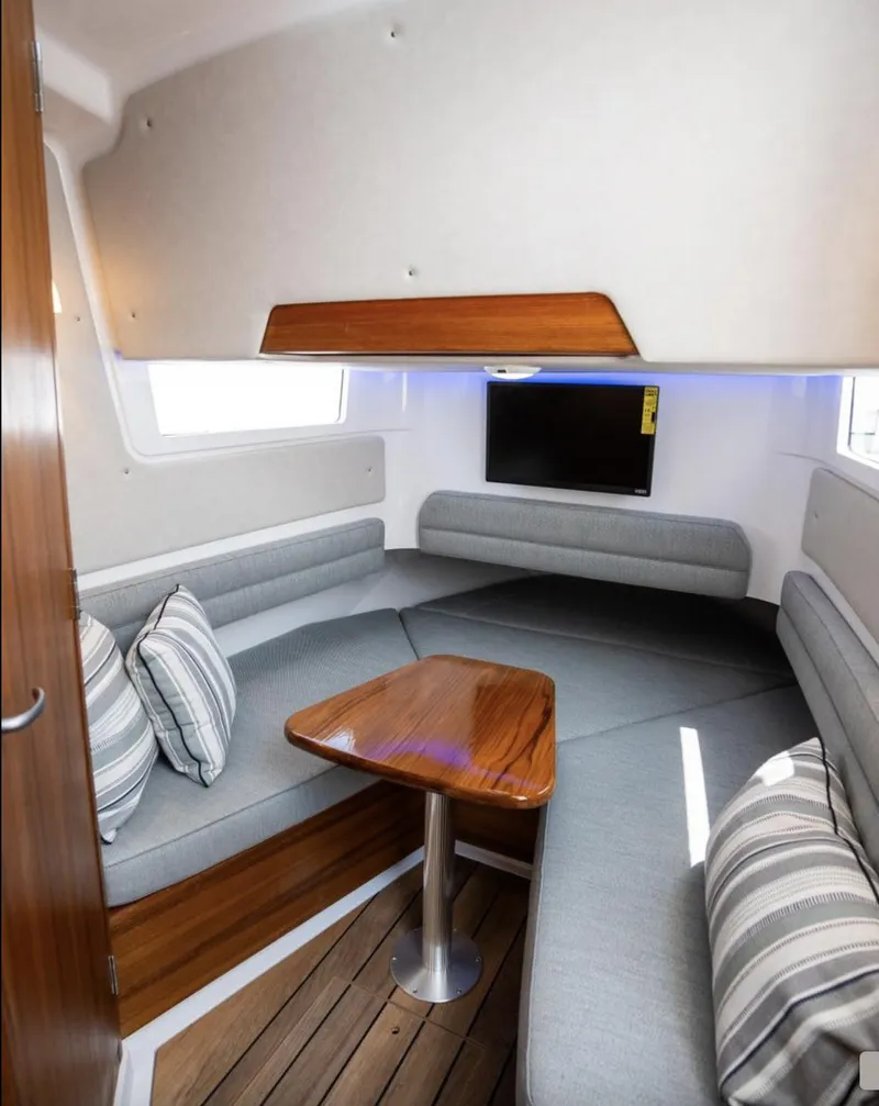 Slide: The Image of 2025 Southport 38 FE cabin interior with modern seating and wooden table. - 4