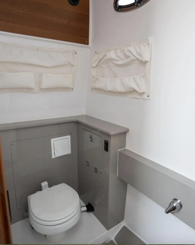 Slide: The Image of 2025 Southport 38 FE boat bathroom with modern fixtures and storage. - 5