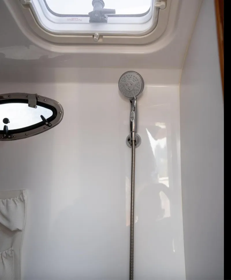 Slide: The Image of Shower area in 2025 Southport 38 FE boat with modern fixtures and overhead window. - 6