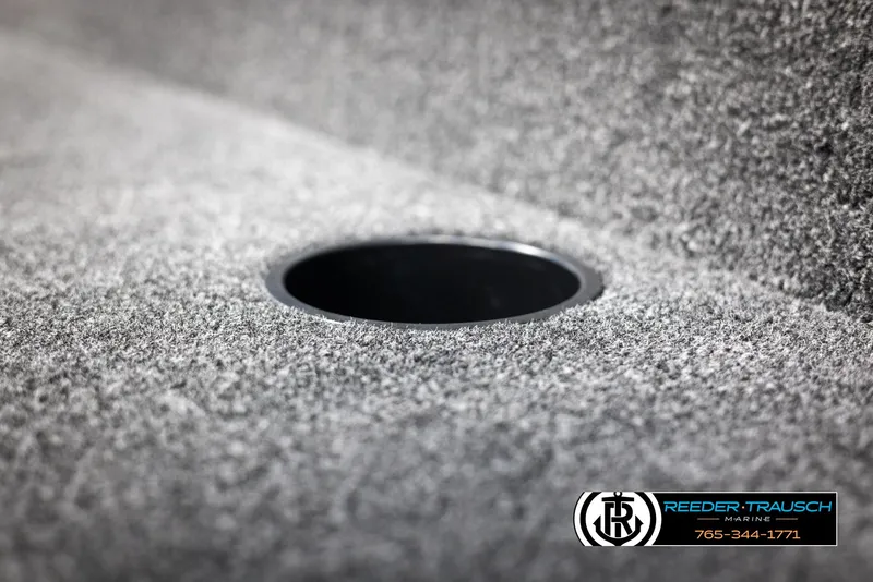 Slide: The Image of 2025 Lund Rebel XL SS boat interior with carpeted surface and cup holder. - 24