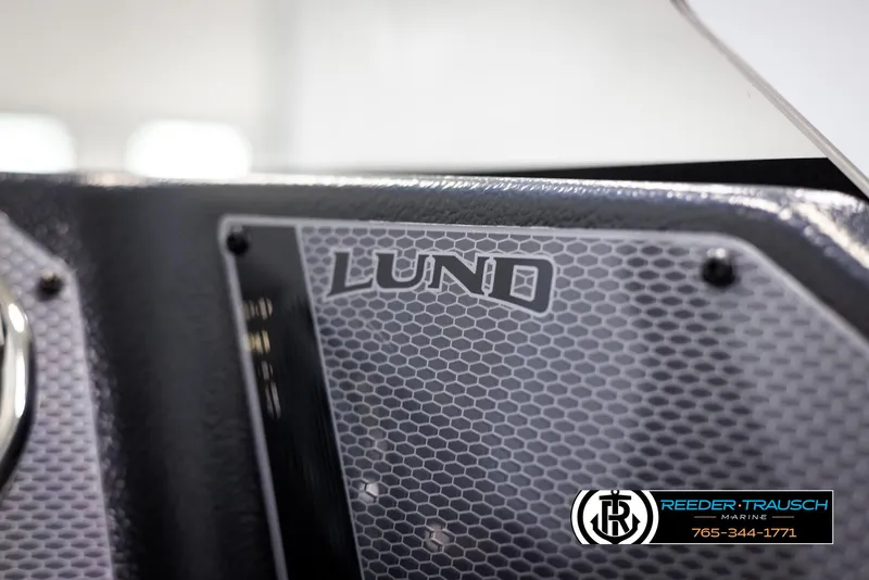 Slide: The Image of 2025 Lund Rebel XL SS boat detail with hexagonal pattern and Reeder-Trausch Marine logo. - 25