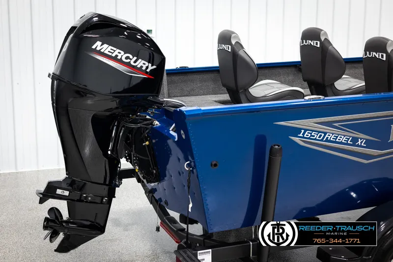 Slide: The Image of 2025 Lund Rebel XL SS boat with Mercury outboard motor, blue exterior, and branded seating. - 30