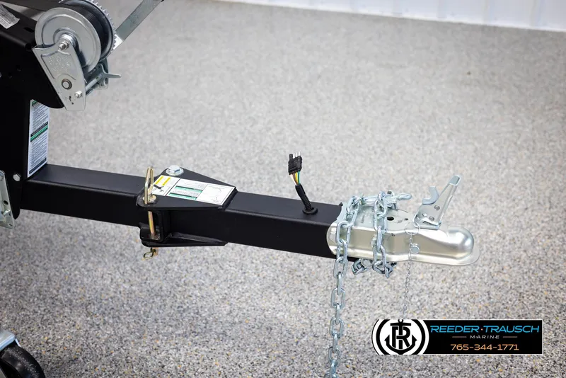 Slide: The Image of Trailer hitch of 2025 Lund Rebel XL SS with safety chains and wiring connector. - 39