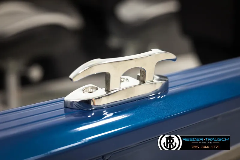 Slide: The Image of 2025 Lund Rebel XL SS boat cleat on blue surface, Reeder-Trausch Marine logo visible. - 42