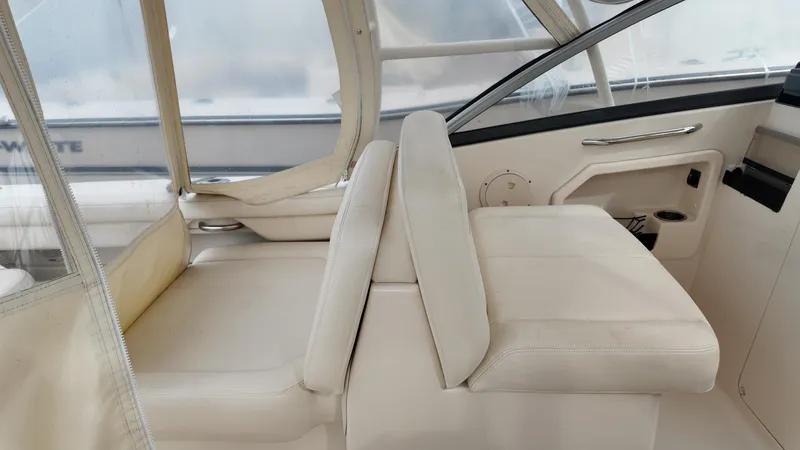 Slide: The Image of 2016 Grady-White Freedom 275 boat interior with white seating and dashboard. - 14