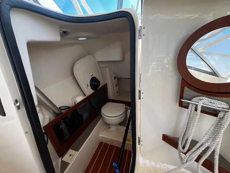 Slide: The Image of 2016 Grady-White Freedom 275 boat interior with toilet and storage area. - 20