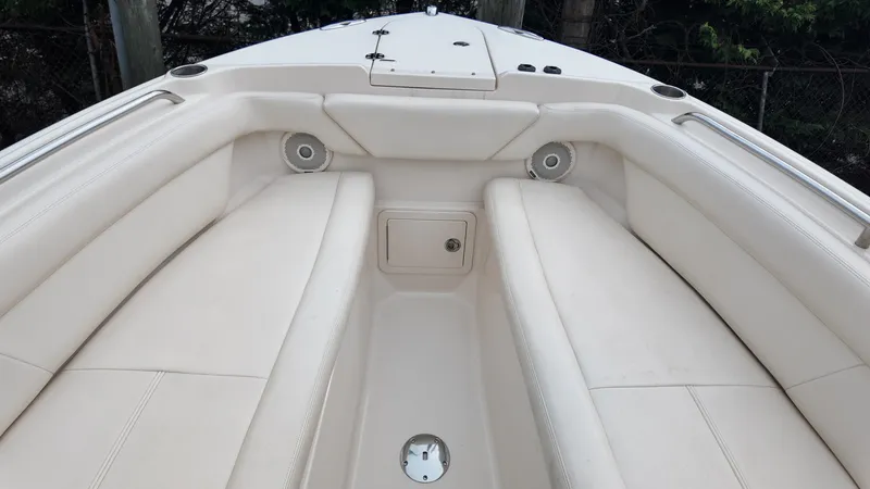 Slide: The Image of 2016 Grady-White Freedom 275 boat interior with white seating and speakers. - 22