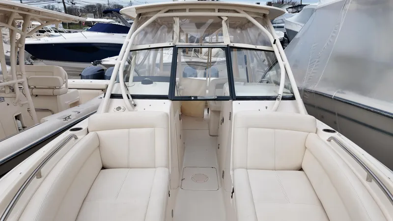 Slide: The Image of 2016 Grady-White Freedom 275 boat interior with white seating and windshield. - 26