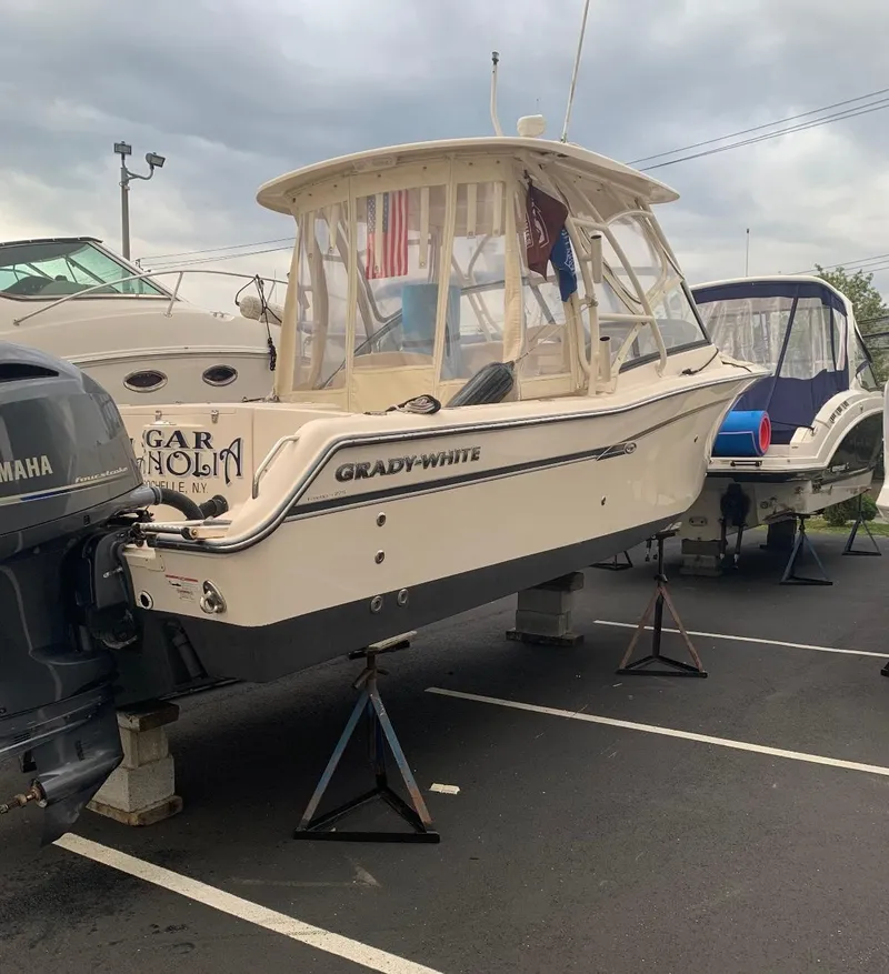 Slide: The Image of 2016 Grady-White Freedom 275 boat on stands in a parking lot. - 28