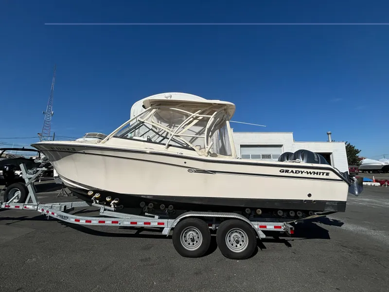 Slide: The Image of 2016 Grady-White Freedom 275 boat on trailer under clear blue sky. - 29