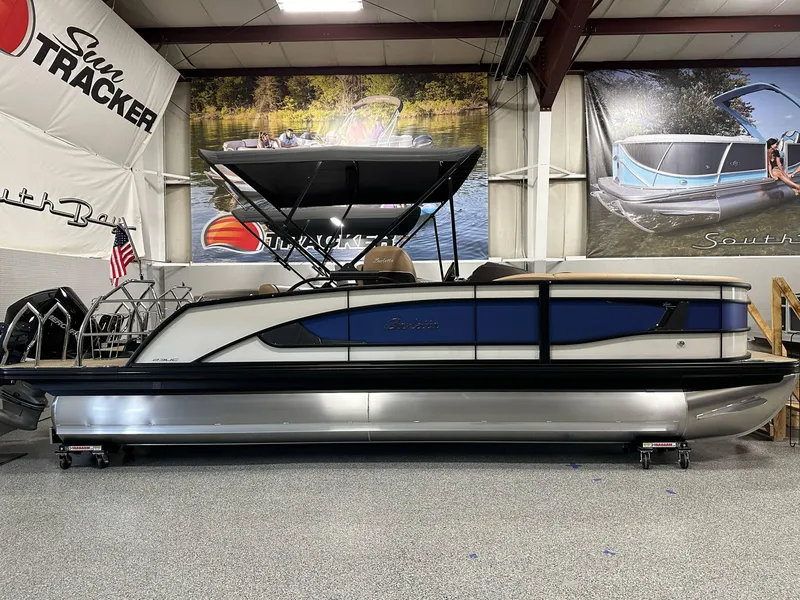 The Image of 2025 Barletta Lusso 23UC pontoon boat displayed in showroom with promotional banners. - 0