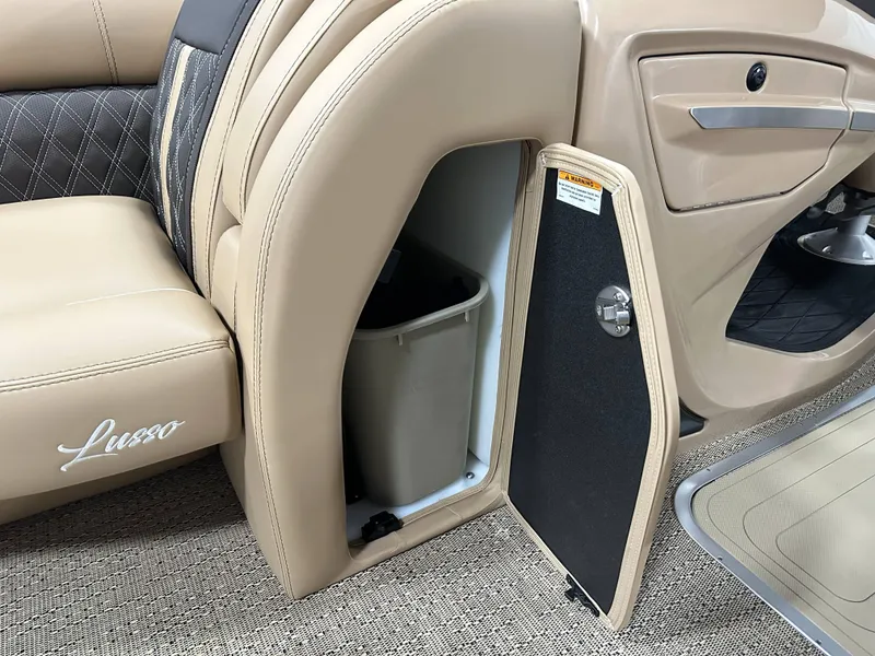 Slide: The Image of 2025 Barletta Lusso 23UC interior storage compartment with open door and trash bin. - 10
